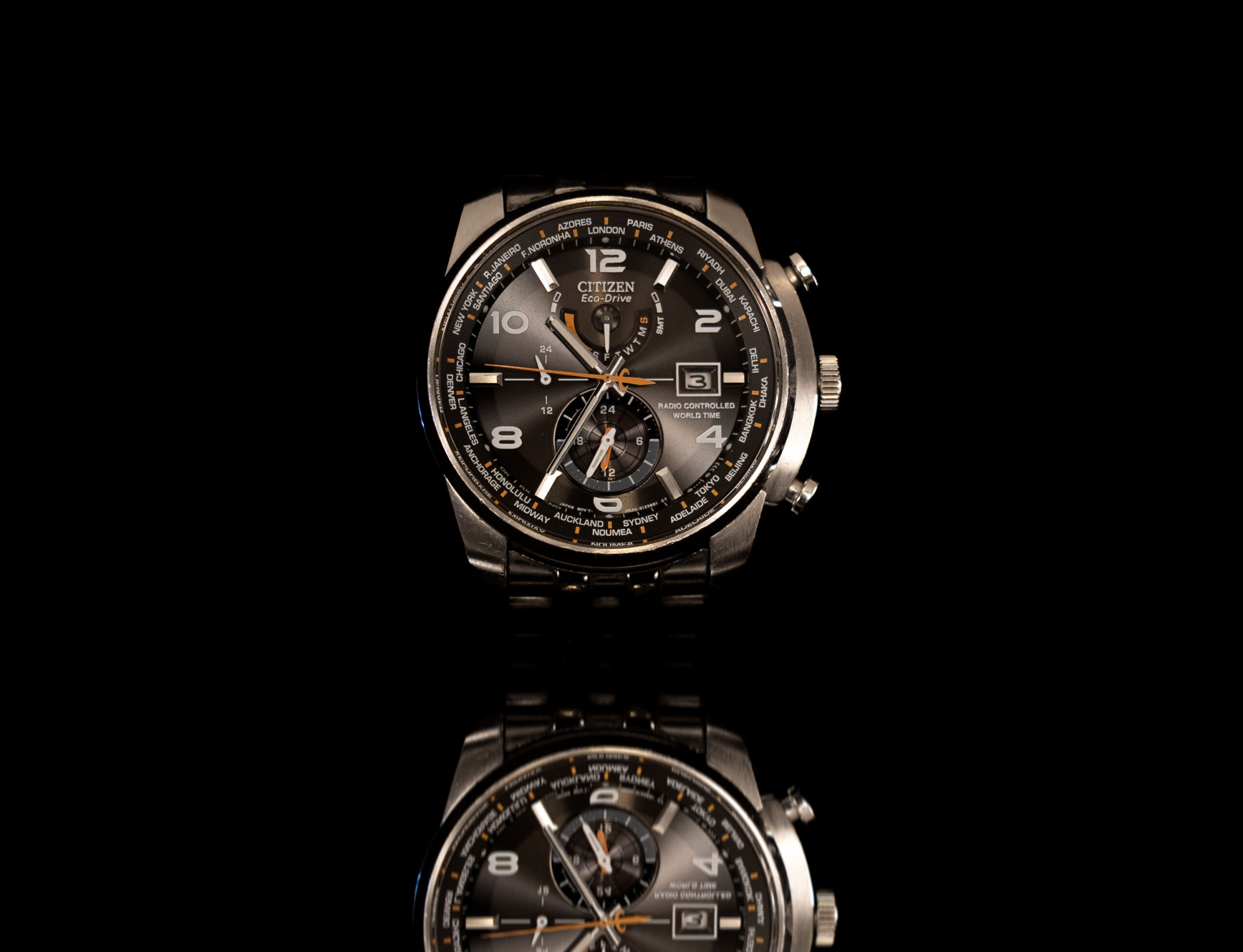 A wrist watch with a black background on a reflective surface. Product Photoshoots for product branding, amazon, shopify listing by Atma-Om Studios in Sydney, New South Wales, Australia. Photography and Videography Services.